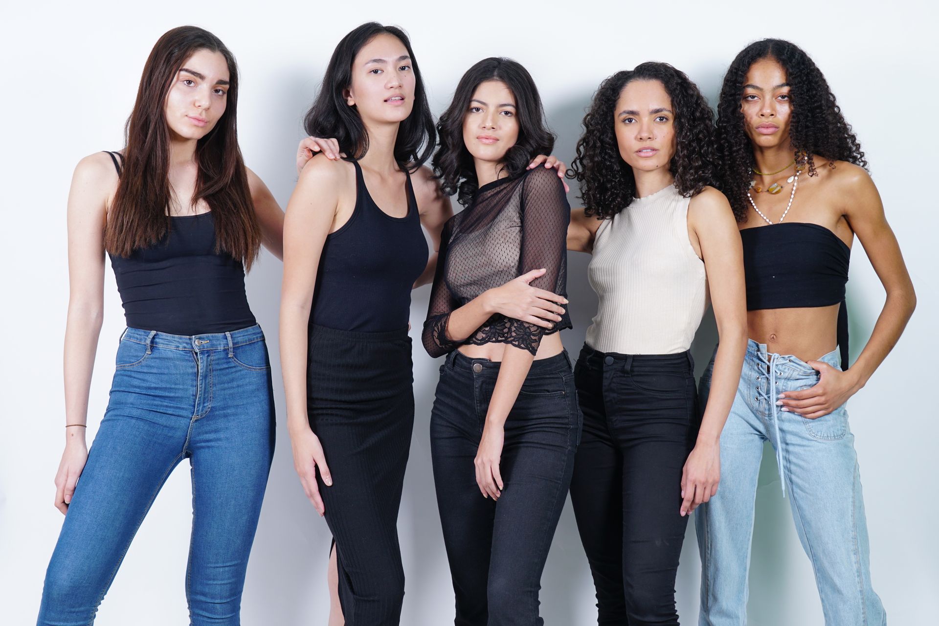 A group of models standing together in the studio