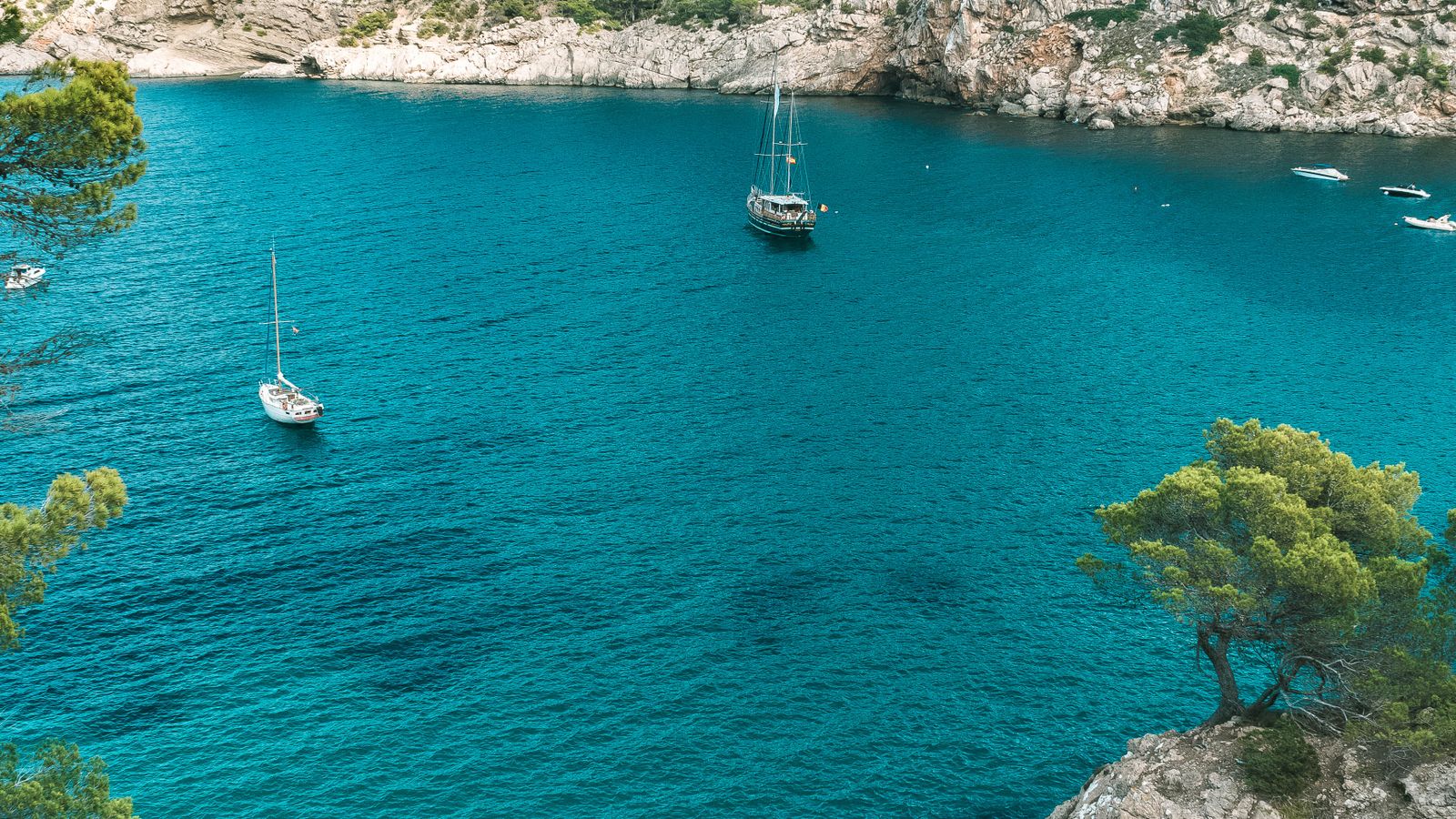 Turquoise cove with sailboats on Ibiza